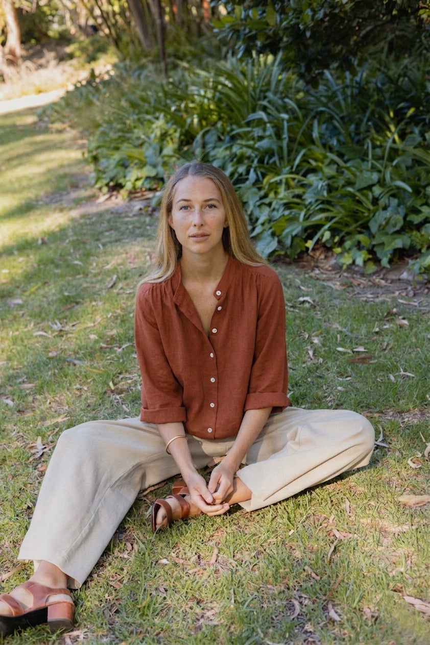 Woman wears navy linen blouse grey stripe wool trouser
