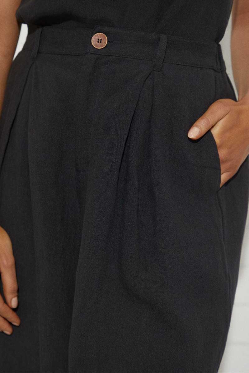 kristin magrit sailor long shorts are short finishing at the knee, a longer length short, colour black organic linen, Buttons made from sustainable coconut shell, detail pocket.