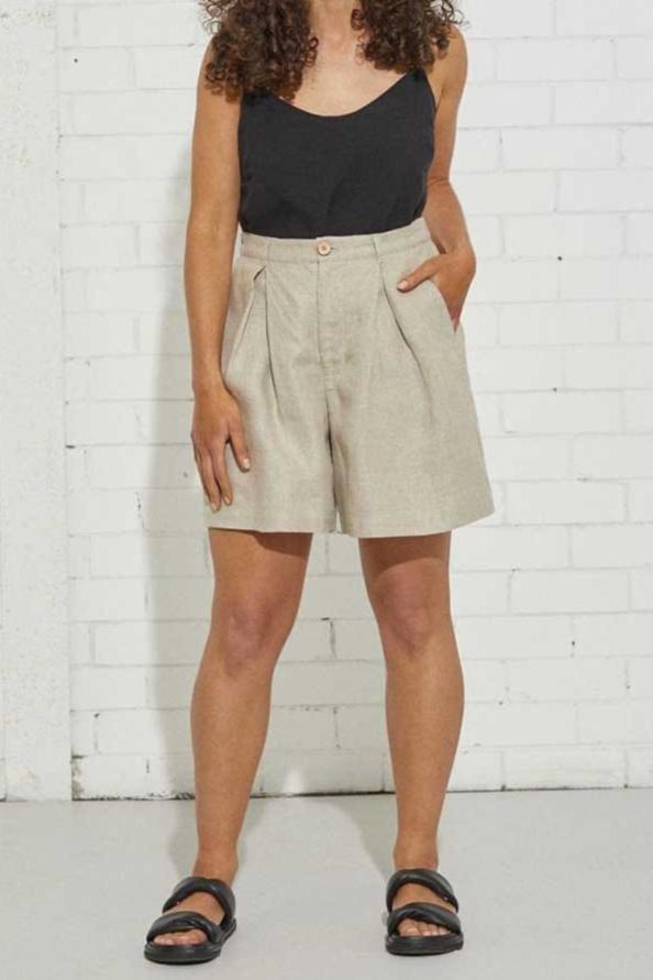 kristin magrit sailor shorts are not too short, but are nice and light and flowy with a deep front pleat, colour natural organic hemp, Buttons made from sustainable coconut shell, model standing in studio front view