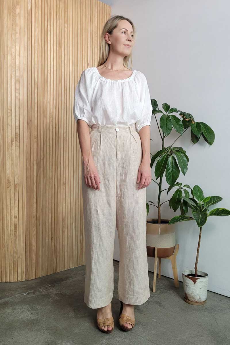 kristin magrit striped sailor pant colour white stripe linen, A long chic leg line with a flattering wide leg cut, Buttons made from sustainable white River Shell, model standing in studio