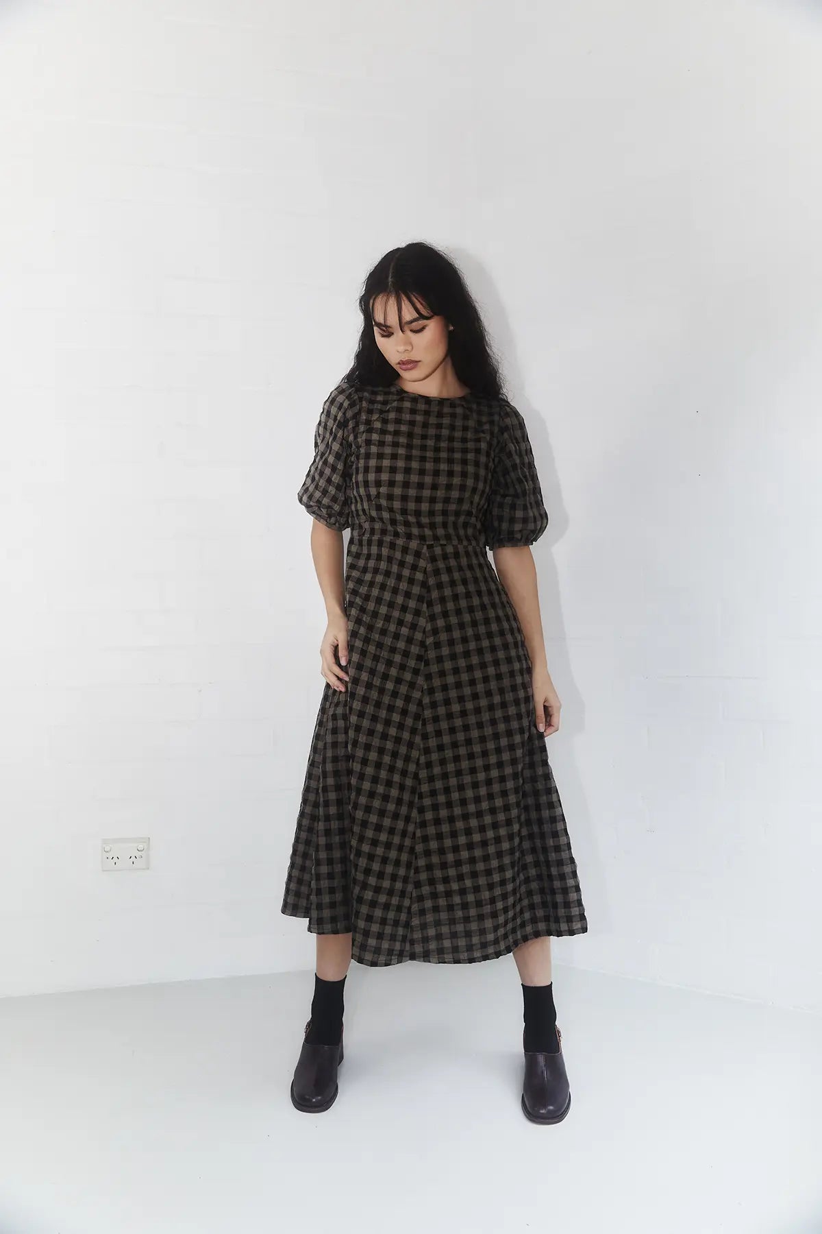 model standing in a line gingham dress colour mocha and black 