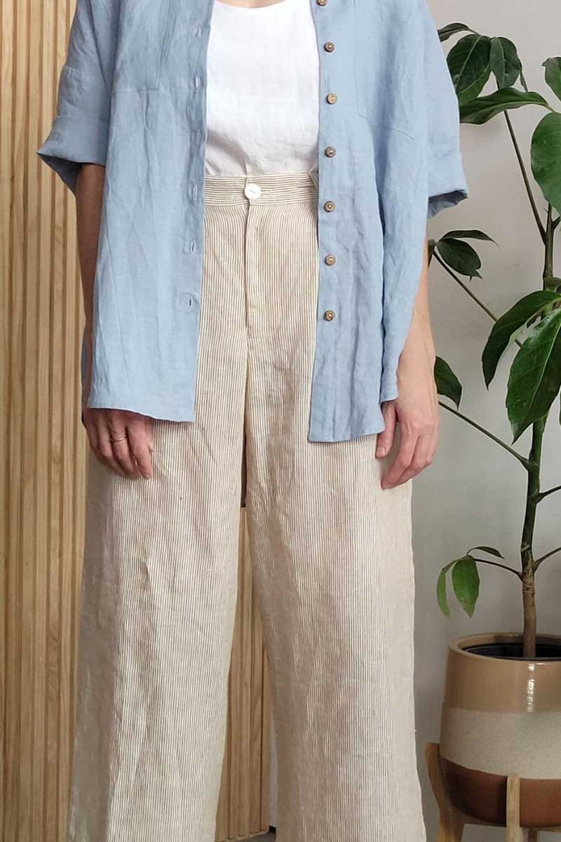 kristin magrit striped sailor pant colour white stripe linen, A long chic leg line with a flattering wide leg cut, Buttons made from sustainable white River Shell, model standing front detail