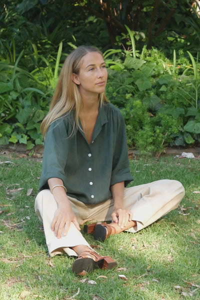 A woman wearing Pine Green Linen Blouse in a outdoor setting 